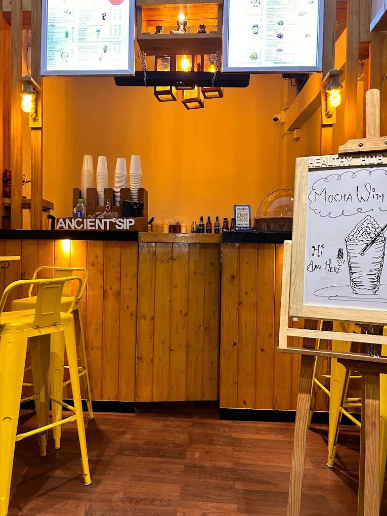 Warm timber counter and seating inside Ancient Sip
